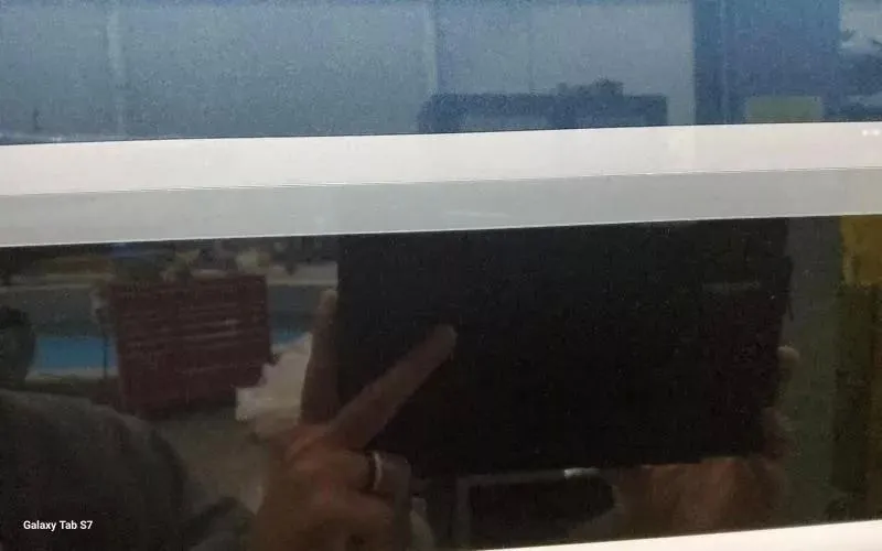 Slide: The Image of Reflection on a window with a person holding a Galaxy Tab S7, indoors. - 5