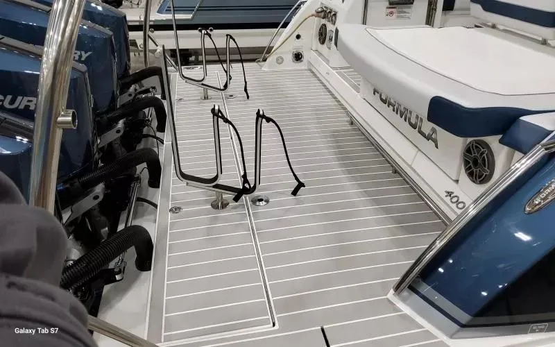 Slide: The Image of 2025 Formula 400 Super Sport Crossover boat deck with seating and Mercury engines. - 6