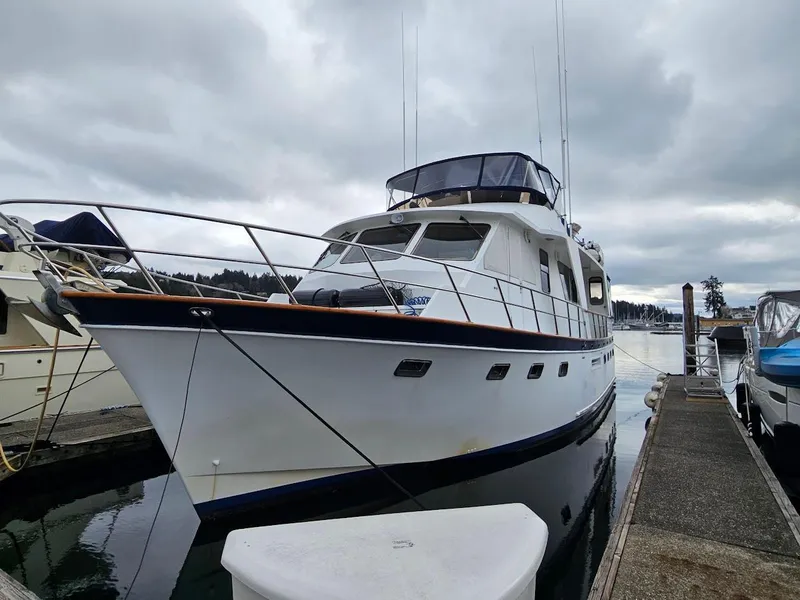 Slide: The Image of 1987 DeFever 53 POC yacht docked in a serene marina setting. - 0