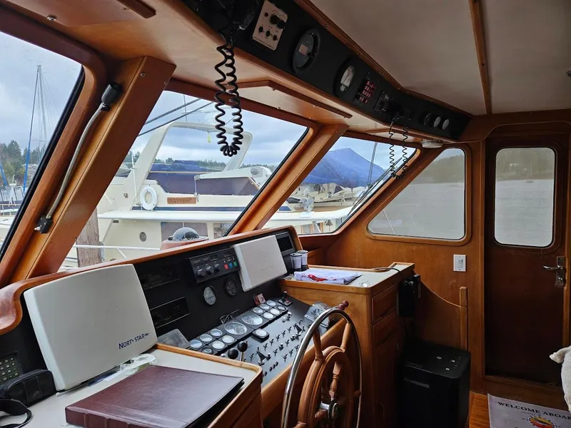 Slide: The Image of 1987 DeFever 53 POC yacht helm with wooden steering wheel and navigation instruments. - 16