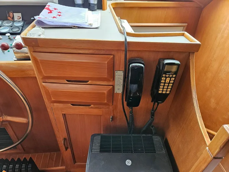 Slide: The Image of 1987 DeFever 53 POC yacht interior with wooden cabinetry and communication devices. - 18