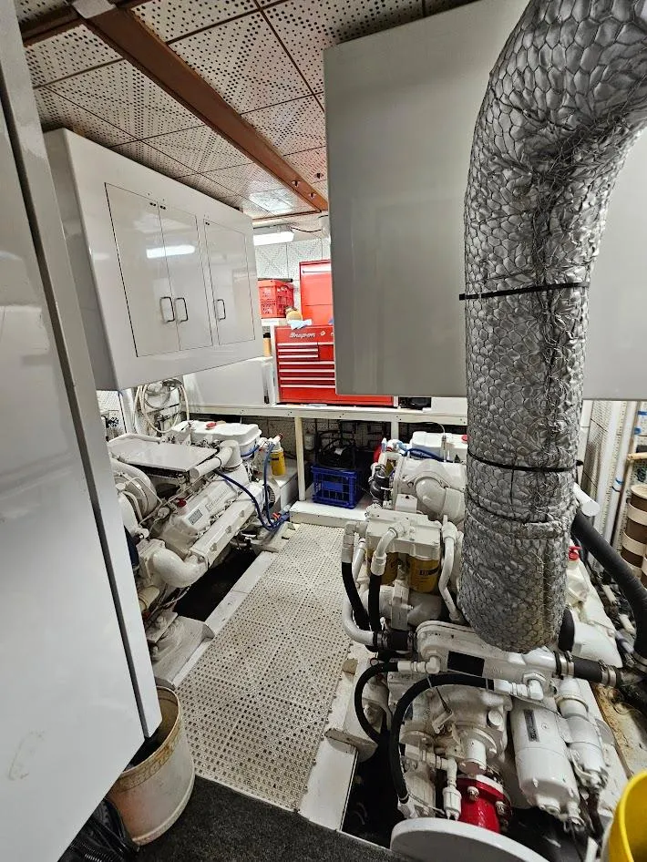 Slide: The Image of Engine room of 1987 DeFever 53 POC yacht with visible machinery and equipment. - 19