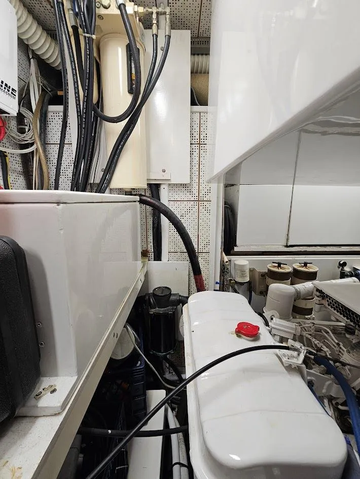 Slide: The Image of Engine room of a 1987 DeFever 53 POC yacht, showcasing mechanical components and equipment. - 23