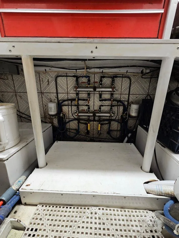 Slide: The Image of Engine room of a 1987 DeFever 53 POC yacht, showcasing mechanical components. - 25