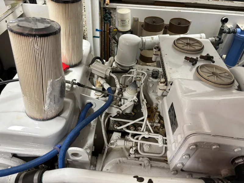 Slide: The Image of Engine room of 1987 DeFever 53 POC yacht, showcasing mechanical components and piping. - 29