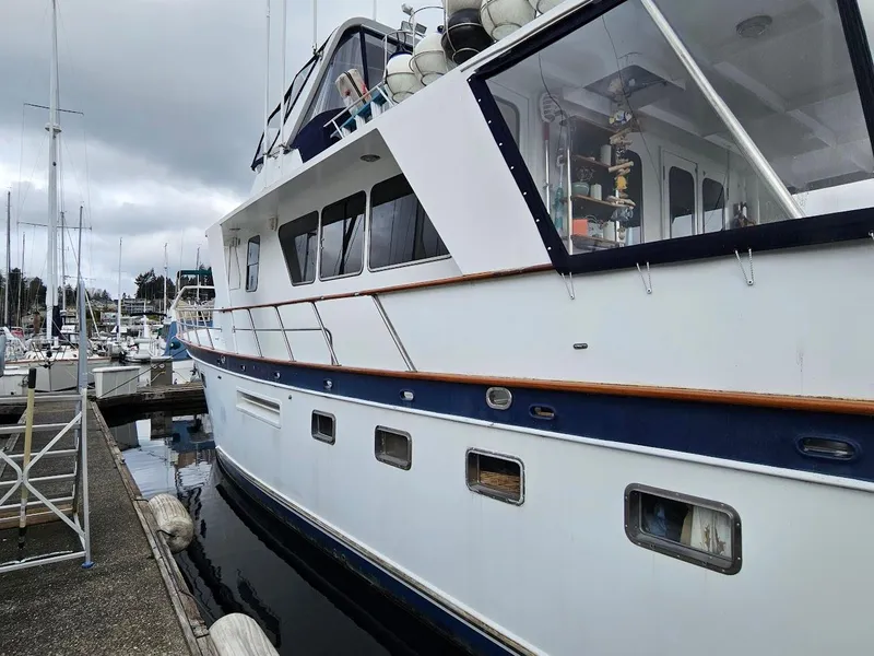 Slide: The Image of 1987 DeFever 53 POC yacht docked at marina under cloudy sky. - 3