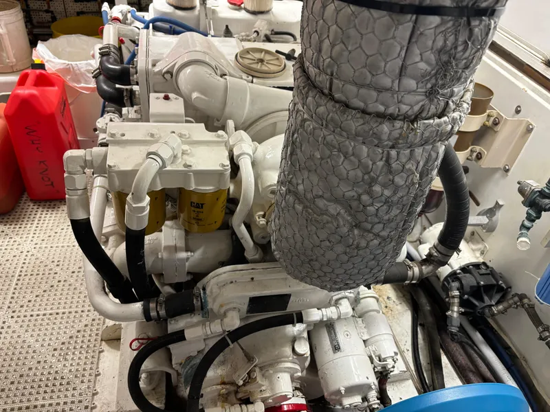 Slide: The Image of Engine room of 1987 DeFever 53 POC yacht with control panel and hoses. - 31