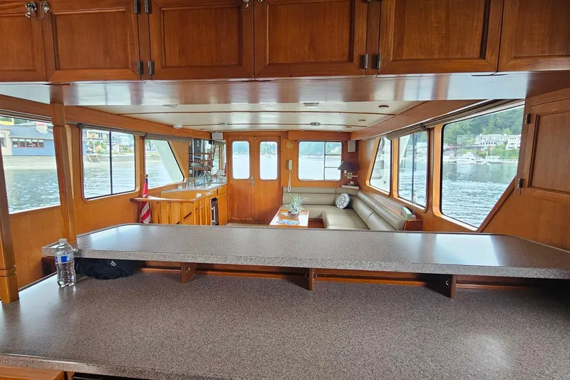 Slide: The Image of Cozy interior of 1987 DeFever 53 POC yacht with scenic window view. - 36