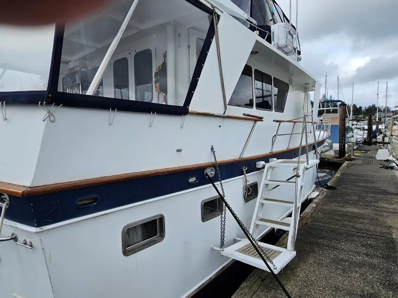 Slide: The Image of 1987 DeFever 53 POC yacht docked at marina under cloudy skies. - 4