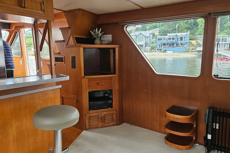Slide: The Image of 1987 DeFever 53 POC yacht interior with kitchenette, wooden cabinetry, and waterfront view. - 42
