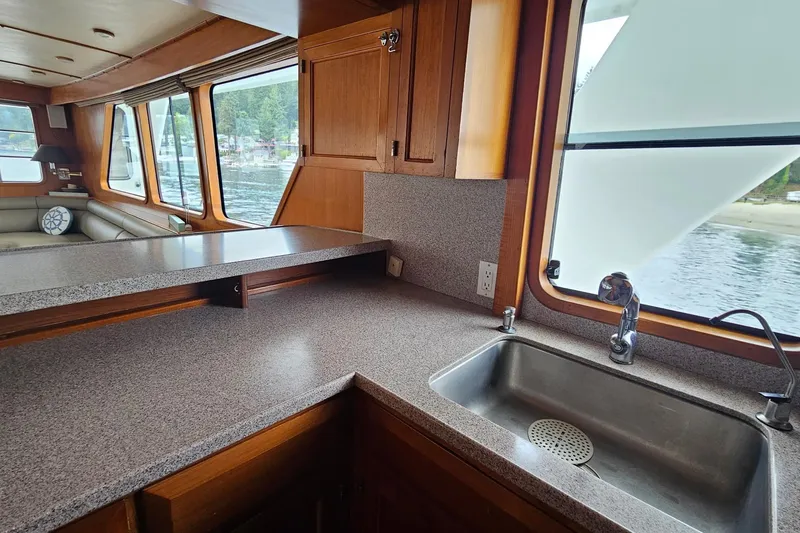 Slide: The Image of 1987 DeFever 53 POC yacht interior with wooden paneling and carpeted stairs. - 44