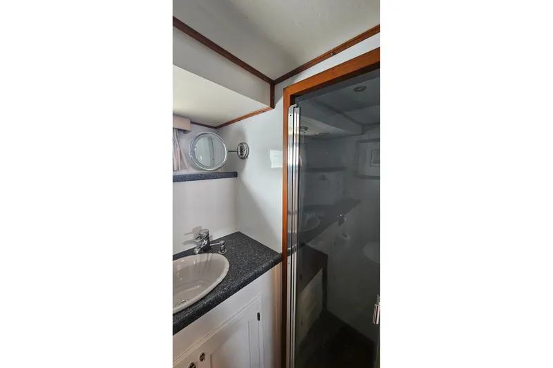 Slide: The Image of 1987 DeFever 53 POC cabin interior with wooden cabinetry and bunk beds. - 48