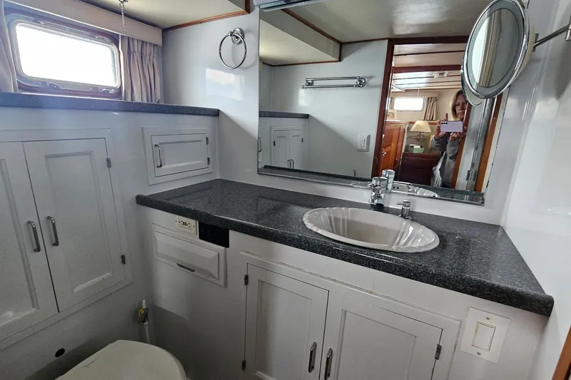 Slide: The Image of 1987 DeFever 53 POC yacht bathroom with sink, mirror, and shower. - 50