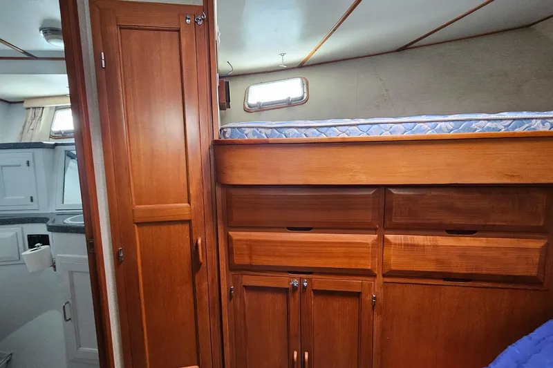 Slide: The Image of Interior of 1987 DeFever 53 POC yacht, featuring wooden stairs and cozy hallway. - 55
