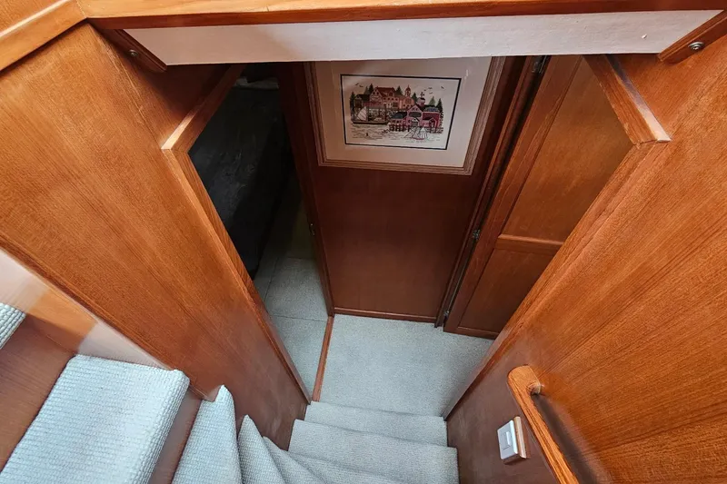 Slide: The Image of 1987 DeFever 53 POC yacht interior with wooden cabinetry and compact bathroom. - 58
