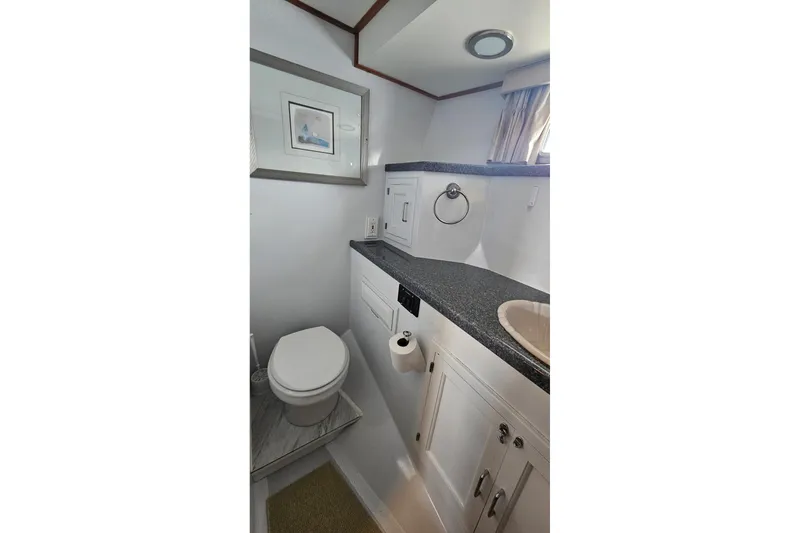 Slide: The Image of 1987 DeFever 53 POC yacht bedroom with wooden furnishings and cozy bedding. - 60