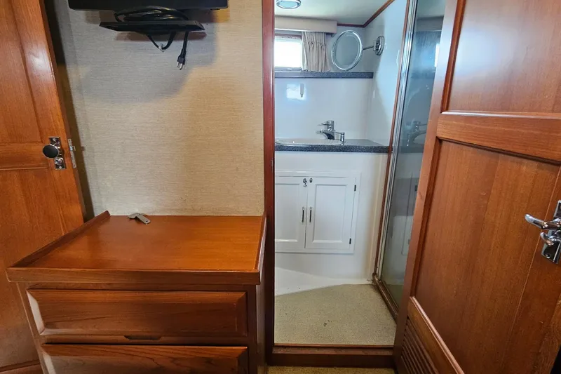 Slide: The Image of 1987 DeFever 53 POC yacht interior with wooden cabinetry and desk area. - 61