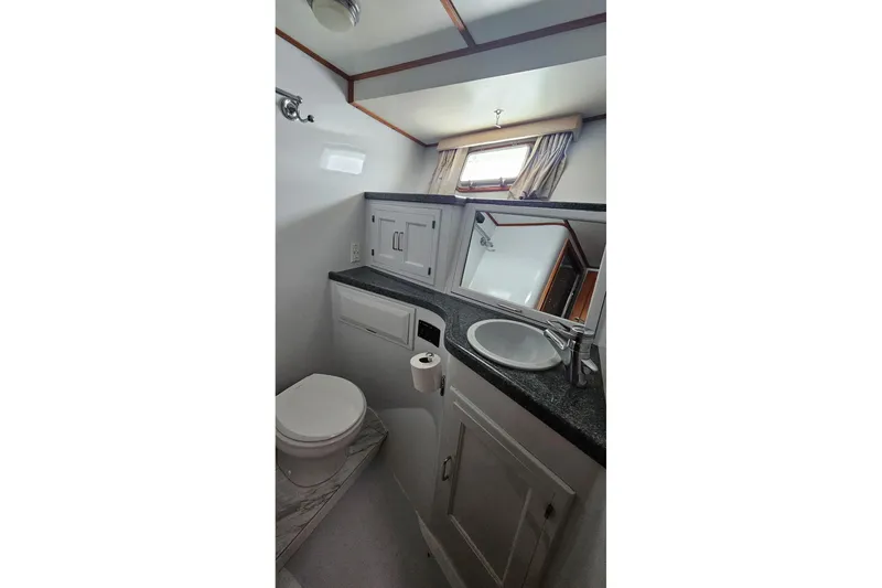 Slide: The Image of 1987 DeFever 53 POC cabin interior with wooden desk, mirror, and storage drawers. - 62
