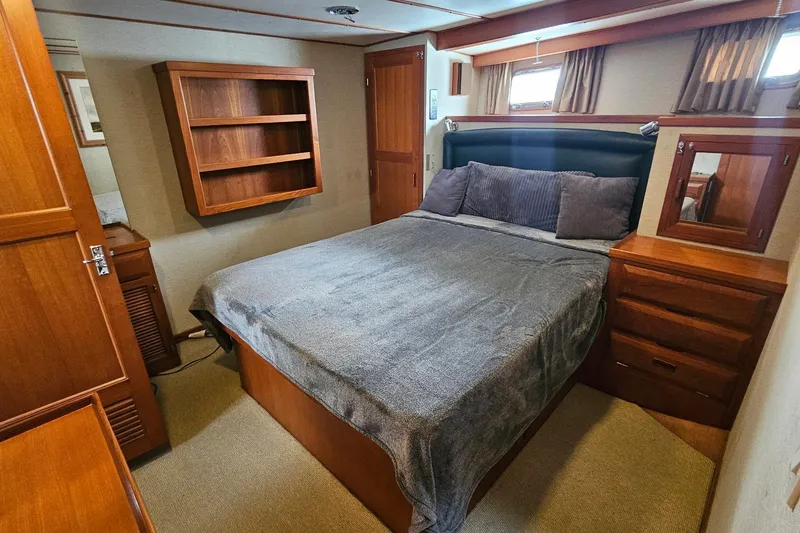 Slide: The Image of Interior view of 1987 DeFever 53 POC yacht, featuring wooden stairs and elegant design. - 63
