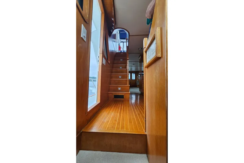 Slide: The Image of Luxurious 1987 DeFever 53 POC yacht bedroom with elegant wood cabinetry and cozy bedding. - 66