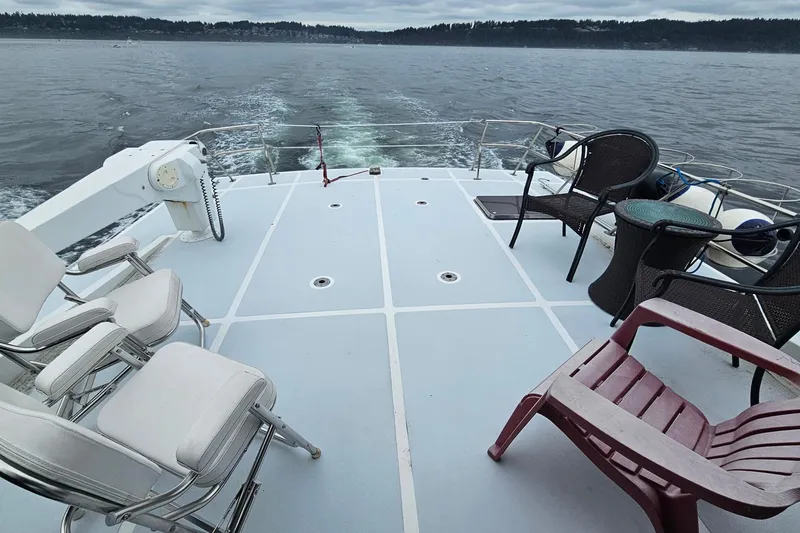 Slide: The Image of 1987 DeFever 53 POC yacht docked, showcasing exterior design and boarding ladder. - 7