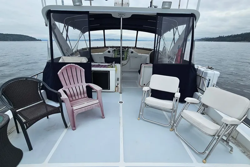 Slide: The Image of 1987 DeFever 53 POC yacht interior with striped seating and ocean view. - 8