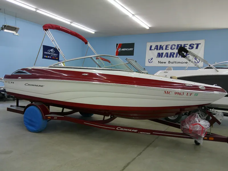 Slide: The Image of 2018 Crownline 205 SS boat in showroom, red and white design, Lakecrest Marine. - 0