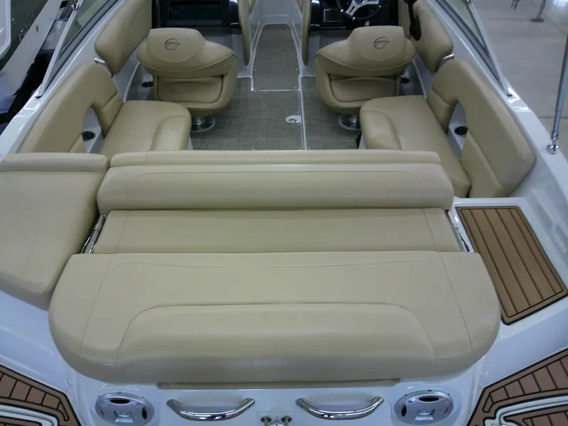 Slide: The Image of 2018 Crownline 205 SS boat interior with beige seating and wood accents. - 10