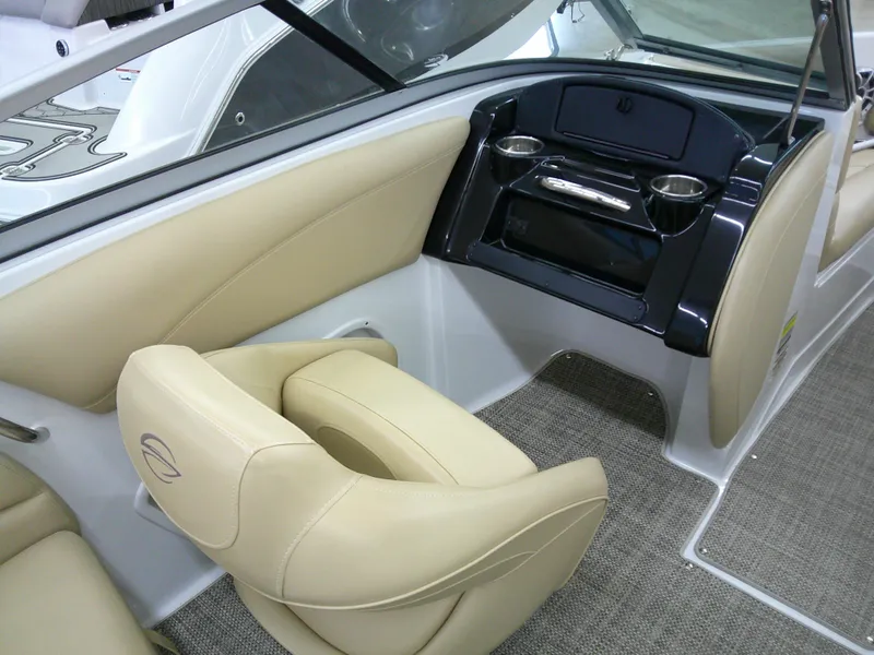 Slide: The Image of Interior of 2018 Crownline 205 SS boat with beige seating and dashboard. - 12