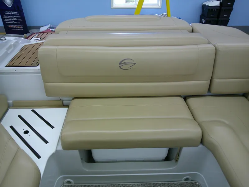 Slide: The Image of 2018 Crownline 205 SS boat interior with beige seating and storage compartment. - 13