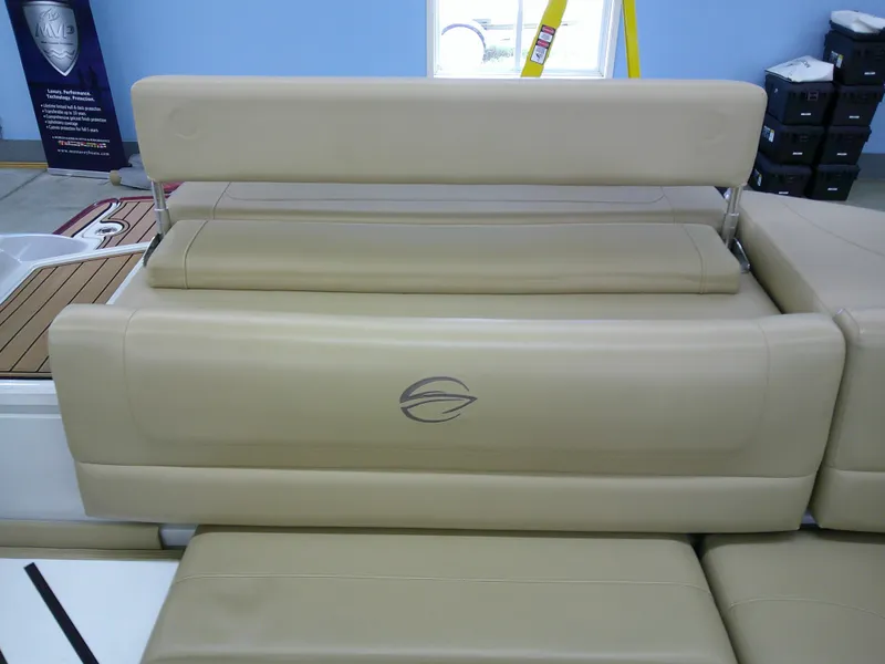 Slide: The Image of 2018 Crownline 205 SS boat interior with beige seating and logo. - 14