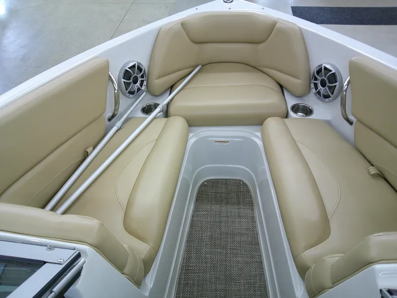 Slide: The Image of 2018 Crownline 205 SS boat interior with beige seating and speakers. - 15