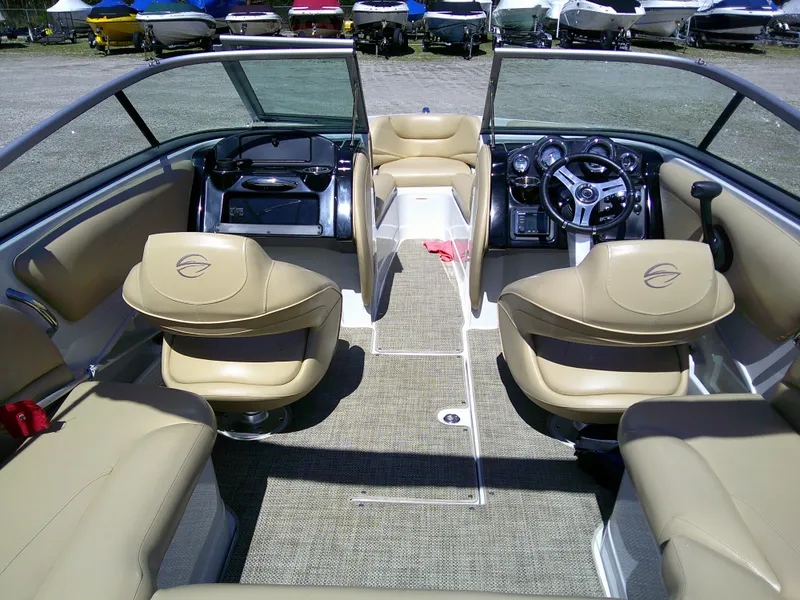 Slide: The Image of 2018 Crownline 205 SS boat interior with beige seating and modern dashboard. - 3