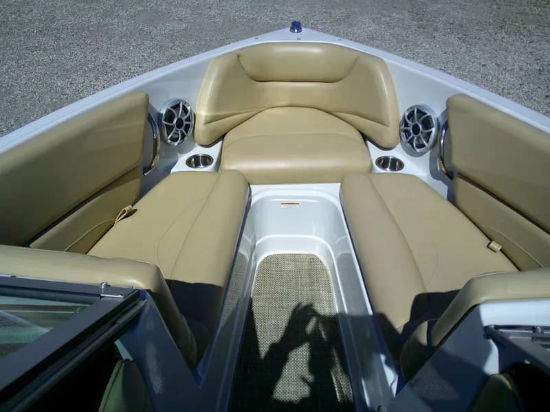 Slide: The Image of 2018 Crownline 205 SS boat interior with beige seating and cup holders. - 4