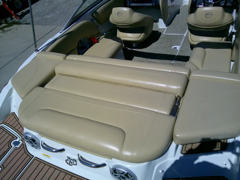 Slide: The Image of 2018 Crownline 205 SS boat interior with beige leather seating and modern design. - 5