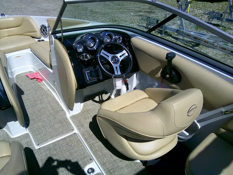 Slide: The Image of 2018 Crownline 205 SS boat interior with beige seating and modern dashboard. - 7