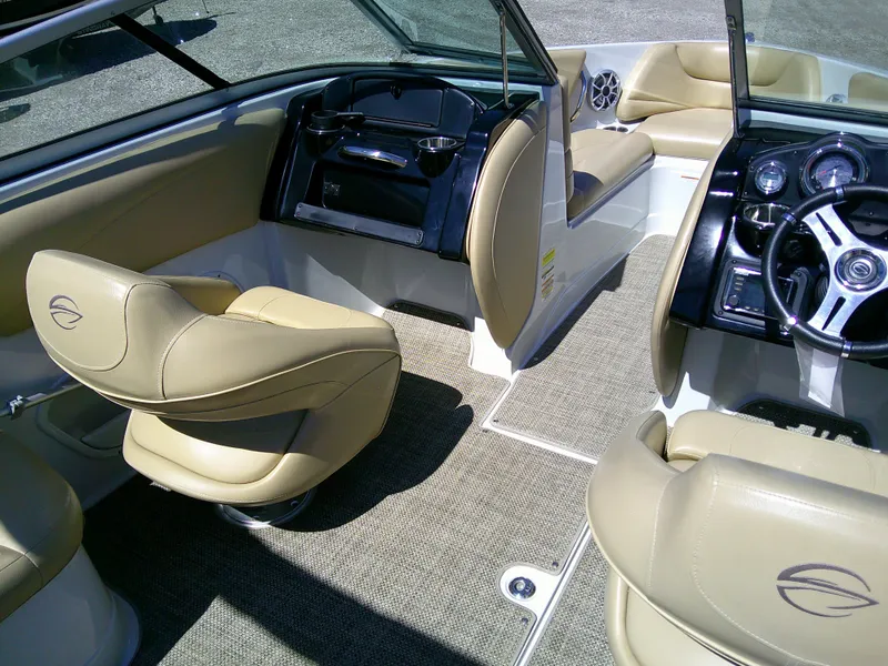 Slide: The Image of 2018 Crownline 205 SS boat interior with beige seating and modern dashboard. - 8