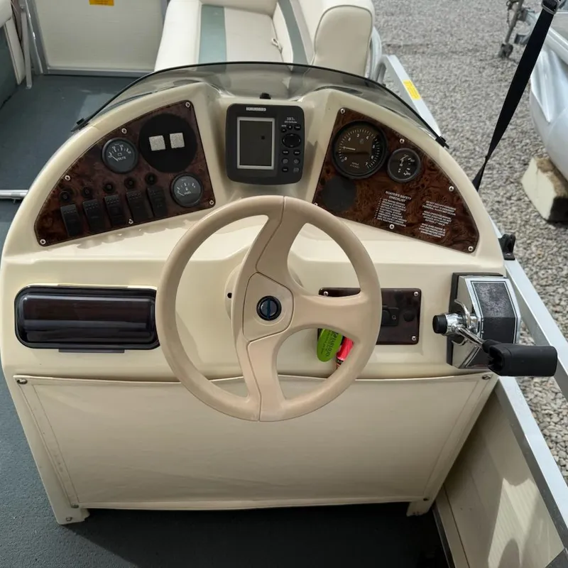 Slide: The Image of Steering console of a 2001 Playbuoy PB Calypso SE boat with gauges and controls. - 10