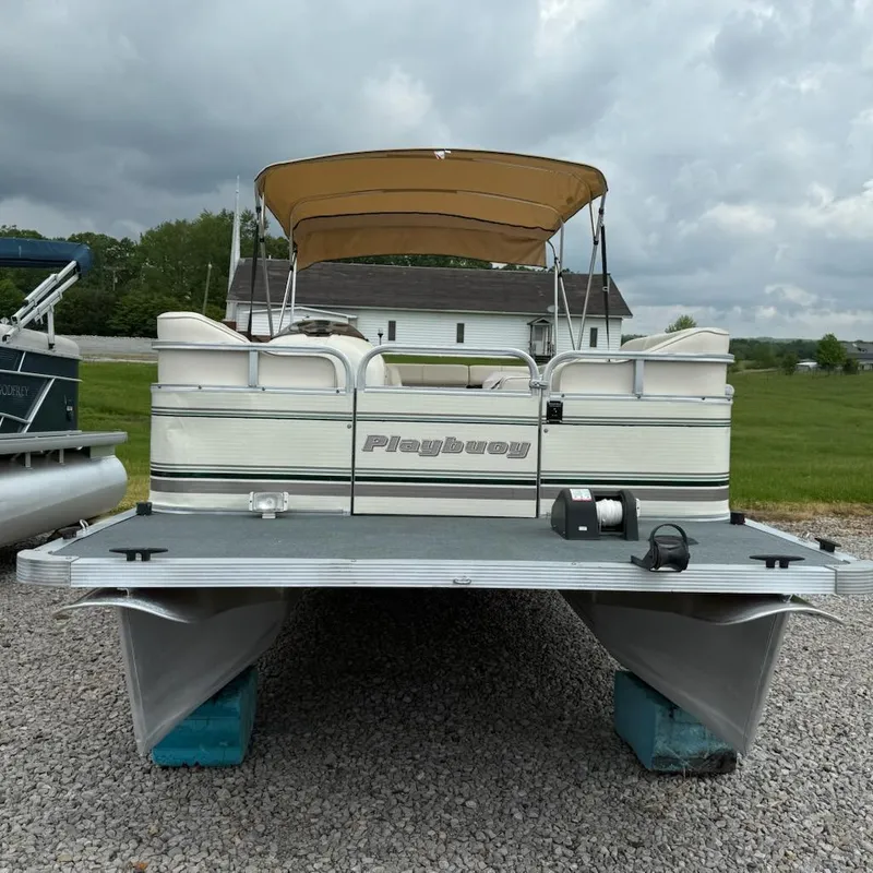 Slide: The Image of Playbuoy PB Calypso SE 2023 pontoon boat on gravel, overcast sky. - 3