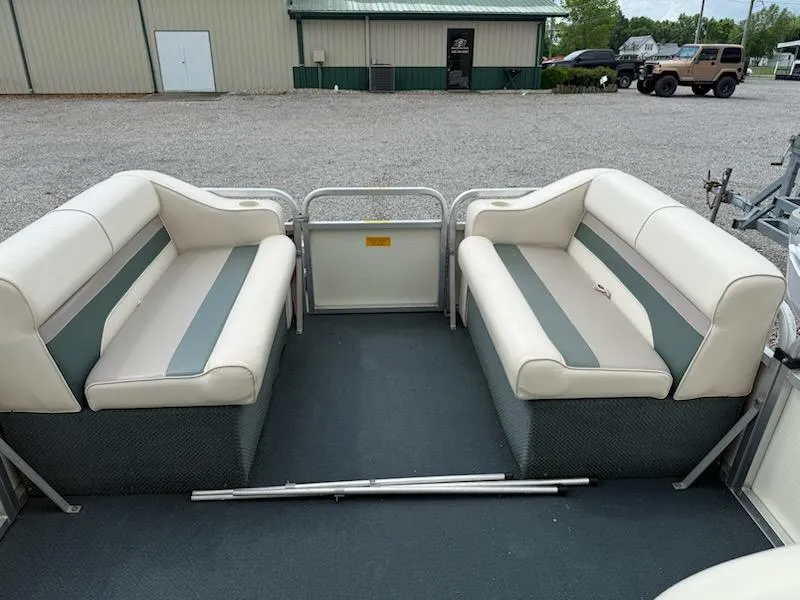 Slide: The Image of Interior of a 2001 Playbuoy PB Calypso SE pontoon boat with cushioned seating. - 8