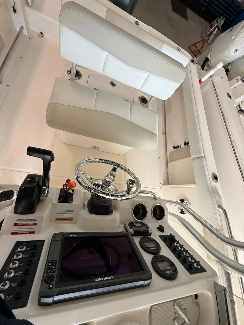 Slide: The Image of 2015 Robalo R222 Center Console boat interior with steering wheel and control panel. - 12