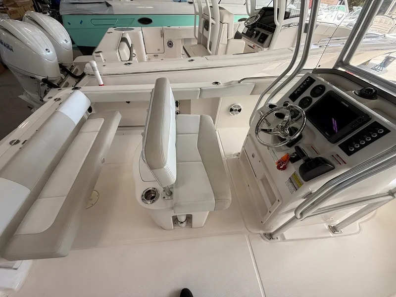 Slide: The Image of 2015 Robalo R222 Center Console boat interior with steering wheel and seating. - 13