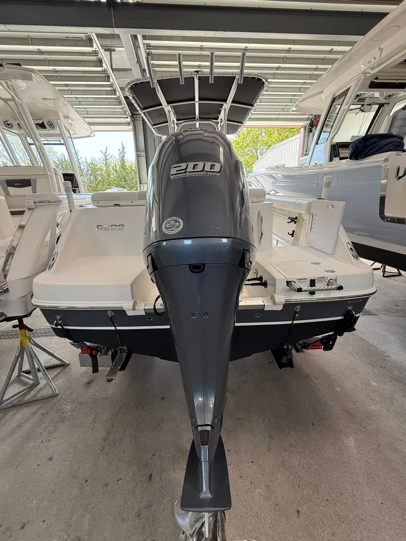 Slide: The Image of 2015 Robalo R222 Center Console boat with powerful 200 HP engine in storage. - 2