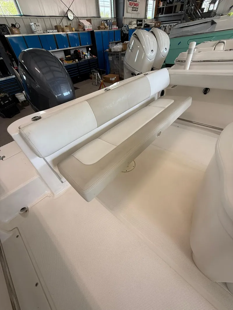 Slide: The Image of 2015 Robalo R222 Center Console boat interior with seating and engine view. - 3