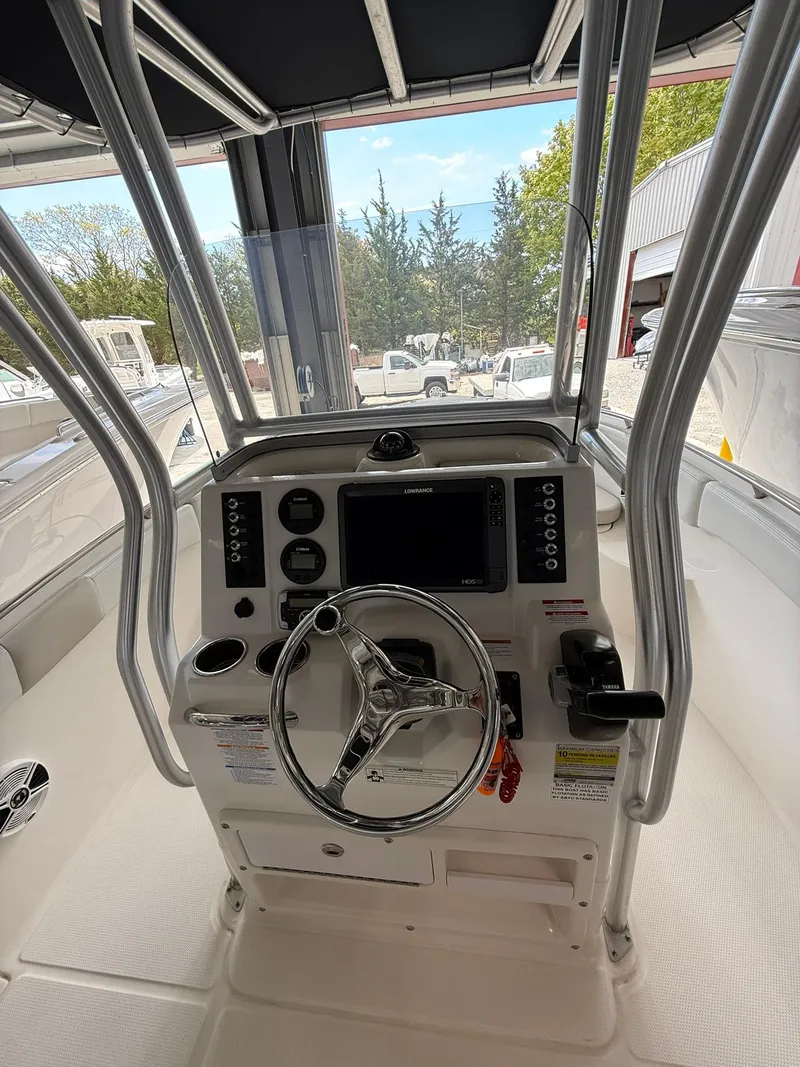 Slide: The Image of 2015 Robalo R222 Center Console boat interior with steering wheel and control panel. - 6