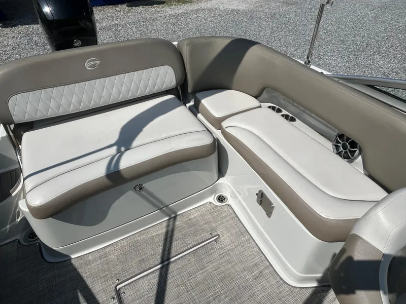 Slide: The Image of 2021 Crownline Eclipse E215 XS boat interior with beige and white seating. - 11