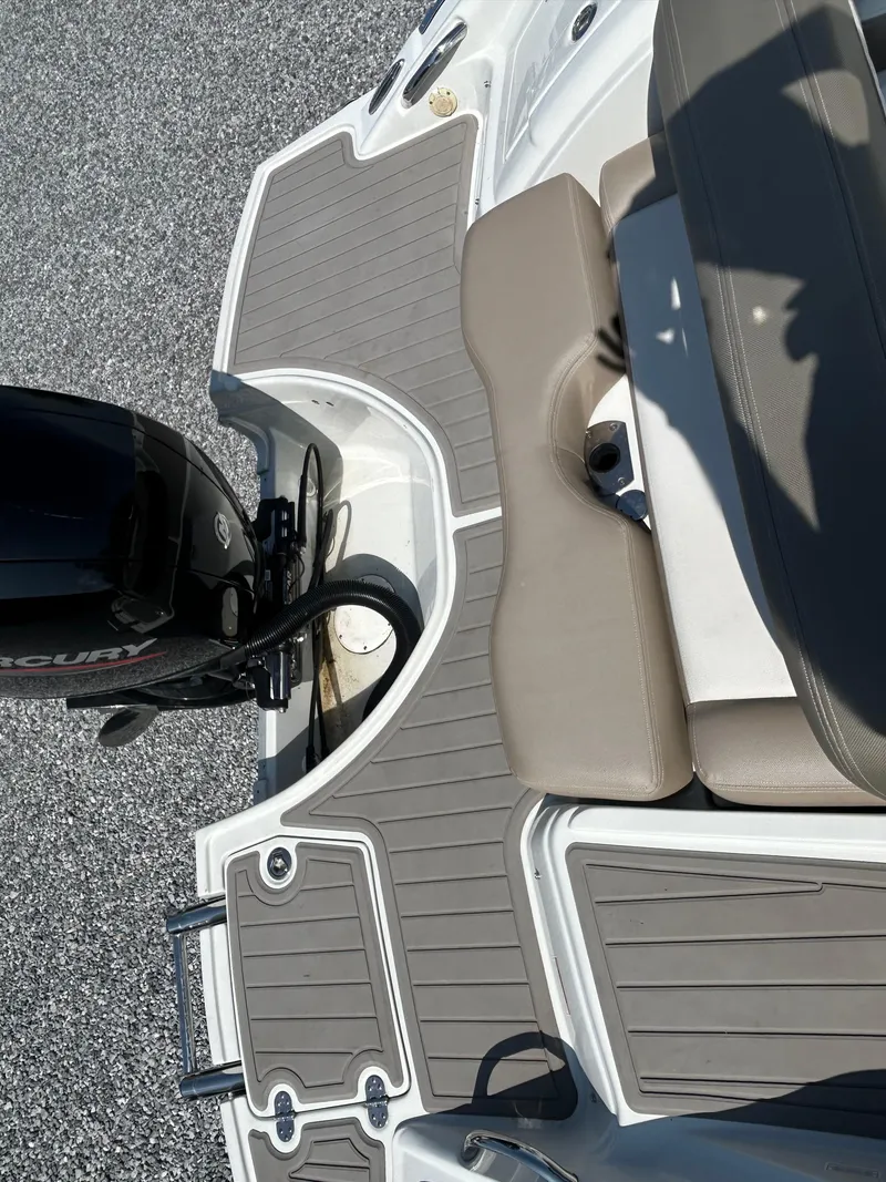 Slide: The Image of 2021 Crownline Eclipse E215 XS boat deck with seating and Mercury outboard motor. - 12