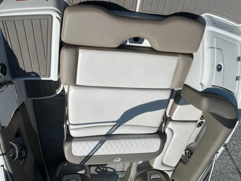 Slide: The Image of 2021 Crownline Eclipse E215 XS boat interior with beige and white seating. - 15
