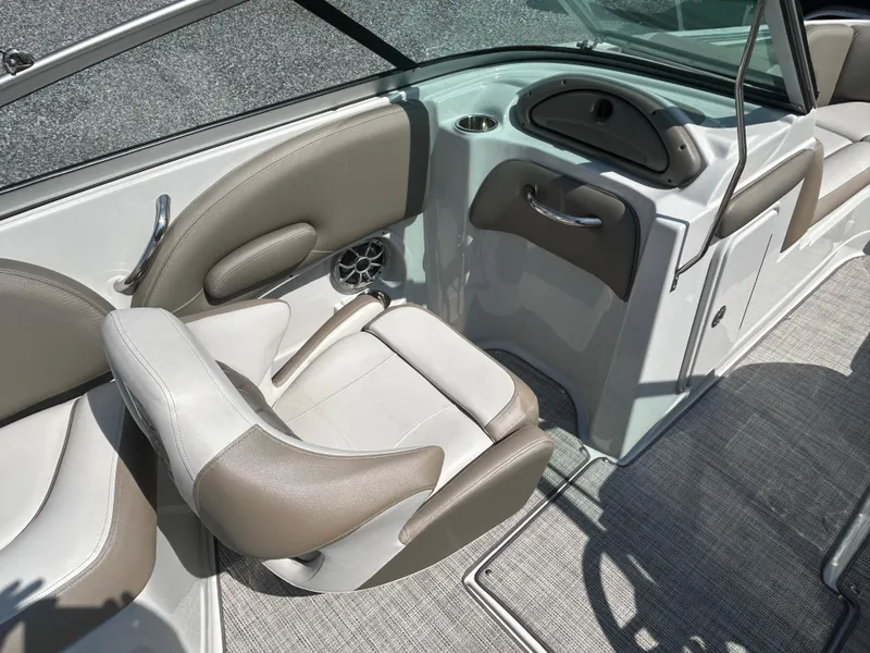 Slide: The Image of 2021 Crownline Eclipse E215 XS boat interior with beige seating and modern design. - 17
