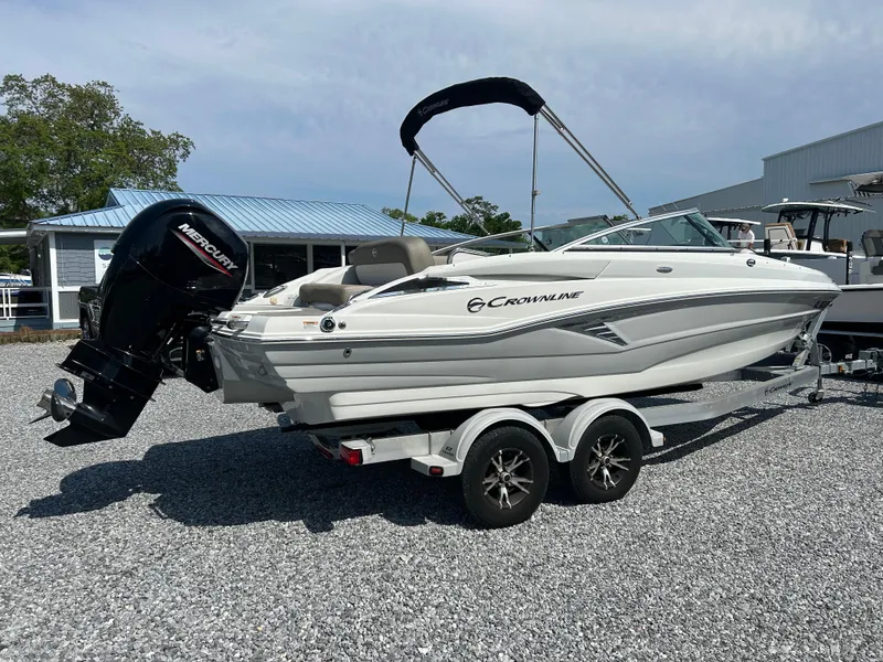 Slide: The Image of 2021 Crownline Eclipse E215 XS boat on trailer, parked outdoors. - 3